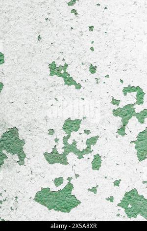 High-resolution image showcasing the texture of an old wall with flakes of green paint peeling off the surface. Stock Photo