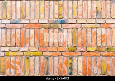 High-resolution image showcasing a textured brick wall with a variety of colors, suitable for backgrounds and design elements. Stock Photo