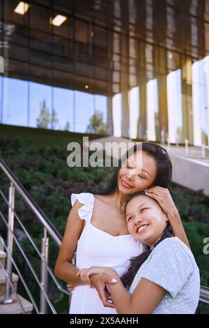 Girl on the autism spectrum having fun with her mother in the city Stock Photo