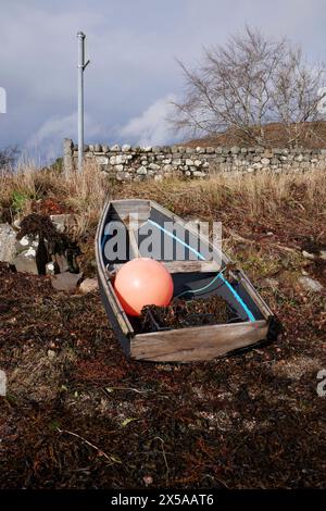 Beached and abandoned wooden dinghy by Ardchattan Pier. Argyll and Bute, Scotland Stock Photo