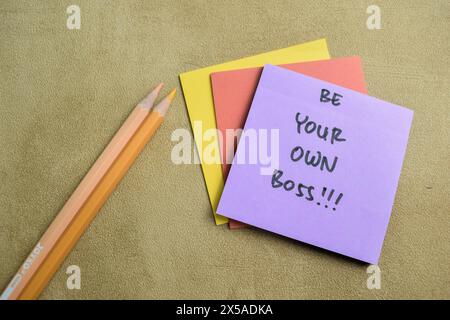 Concept of Be Your Own Bos write on sticky notes isolated on Wooden Table. Stock Photo