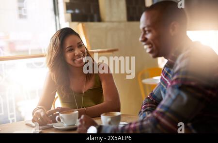 Laughing, students and couple in coffee shop for learning, talking or studying together in restaurant. Happy people, funny and relax in cafe for Stock Photo