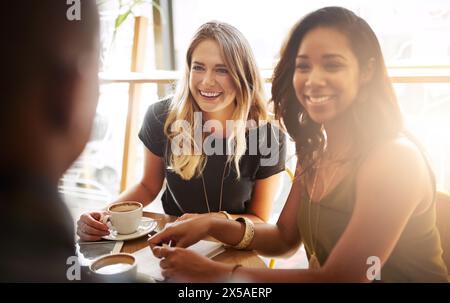 Smile, group and friends drinking coffee in shop for talking, conversation or social gathering together in restaurant. Happy women, students and relax Stock Photo