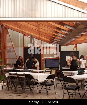 Interior of classroom with wood burner. Cody Dock - The Growing Space, London, United Kingdom. Architect: Live Design Studio, 2023. Stock Photo