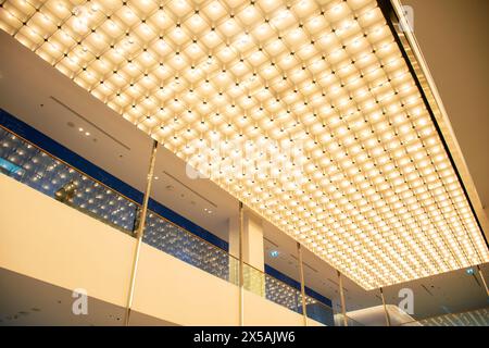 Luxury ceiling in commercial building decorated with warm color lights Stock Photo