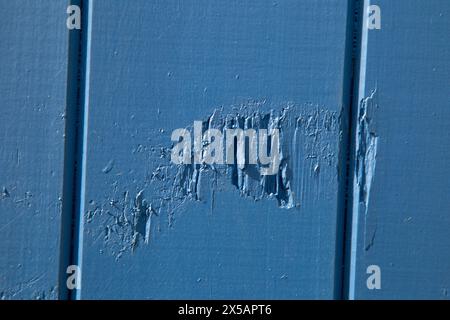 Norfolk,England, April 30th 2024, Close up shot of blue painted timber panels on a beach hut with some damage to the panels Stock Photo
