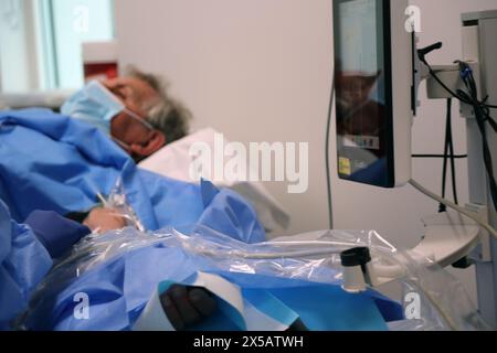 Patient having Peripherally Inserted Central Catheter (Picc Line) Administered under Local Anaesthetic in Hospital Surrey England Stock Photo