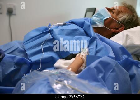 Patient having Peripherally Inserted Central Catheter (Picc Line) Administered under Local Anaesthetic in Hospital Surrey England Stock Photo