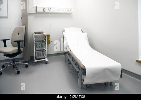 Hospital Gurney with Paper Towels in Empty Room Surrey England Stock Photo