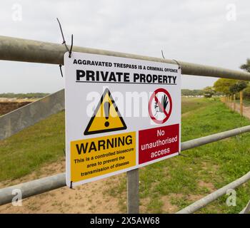 Sign on a gate on the perimeter of a pig farm advising the public of private property and a controlled biosecure area. Covehithe, Suffolk. UK Stock Photo