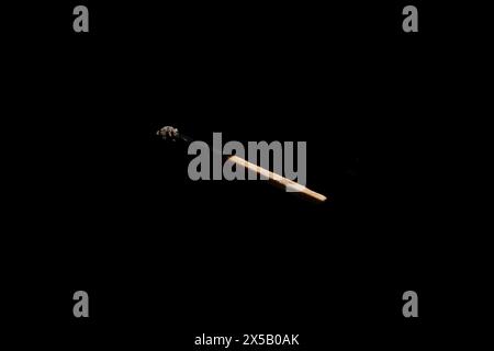 Lit and falling match on a black background. Stock Photo