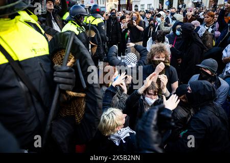 AMSTERDAM - Police officers try to stop support demonstrators on the Rokin. In the morning, the barricades erected by demonstrators at the Binnengasthuis grounds of the University of Amsterdam (UvA) are still visible. Entrances to the site are blocked from several sides with, among other things, pallets and bicycle racks. ANP RAMON VAN FLYMEN netherlands out - belgium out Stock Photo