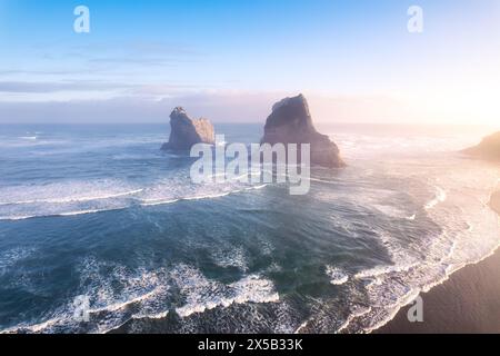 Aerial view of Picturesque sunrise shining over Wharariki beach and archway island on Tasman sea at West of cape farewell, New Zealand Stock Photo
