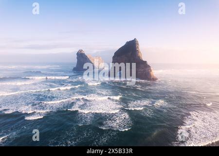Aerial view of Picturesque sunrise shining over Wharariki beach and archway island on Tasman sea at West of cape farewell, New Zealand Stock Photo