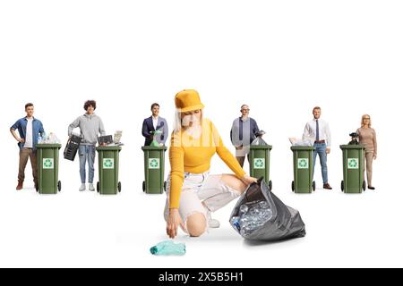 Young female collecting plastic bottles from the ground and people recycling materials isolated on white background Stock Photo