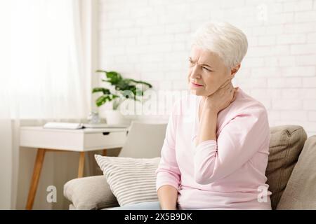 Mature woman suffering from backache at home Stock Photo