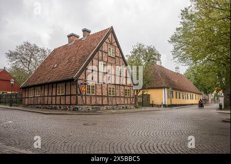 half-timbered red brick-house on a cobblesone street in Lund, Sweden, May 6, 2024 Stock Photo