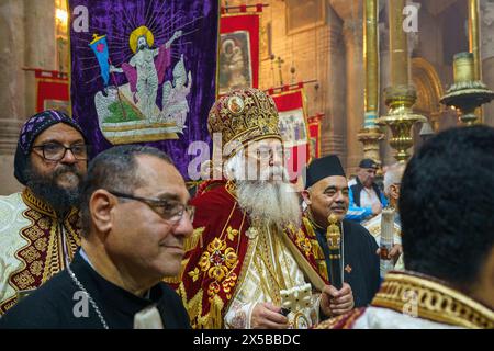 The Metropolitan Archbishop Antoninus of Jerusalem Coptic Patriarchy seen during the procession around the aediculae in the Church of the Holy Sepulchre after the Holy Fire Ceremony. The Holy Fire ceremony is celebrated by orthodox churches in the Church of the Holy Sepulchre in Jerusalem every year before Easter. This spiritual and religious event is one of the most important rituals of the orthodox Christianity, and many pilgrims gather from all around the world to witness it. During the ceremony the Greek Patriarch enters the aediculae where Jesus tomb is located, praying until the holy fir Stock Photo