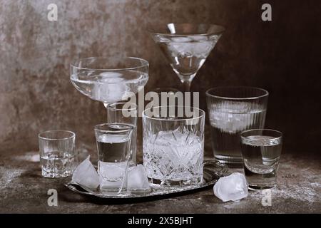 Collection of different glasses filled with cold water with ice Stock Photo