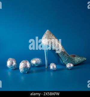 High-heeled fashion shoes that sparkle and aluminum eggs. Creative entertainment concept Stock Photo