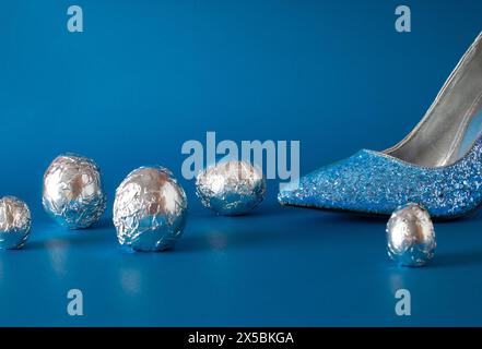 High-heeled fashion shoes that sparkle and aluminum eggs. Creative entertainment concept Stock Photo