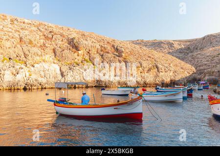 Blue Grotto, Malta - August 22, 2019: Small pleasure boats are anchored at Blue Grotto bay on a sunny morning Stock Photo