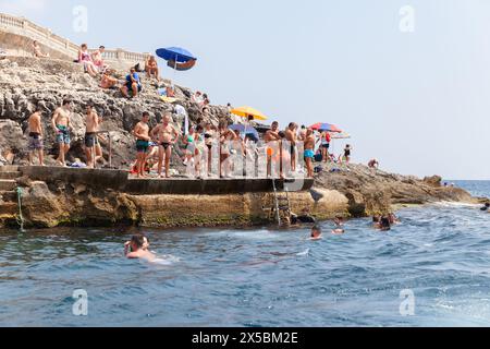 Blue Grotto, Malta - August 22, 2019: Blue Grotto beach full of people on a sunny day, seaside view Stock Photo