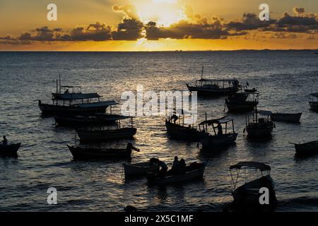 Salvador, Bahia, Brazil - February 01, 2019: Sunset on Rio Vermelho beach with silhouette of fishing boats anchored in the sea. city of Salvador, Bahi Stock Photo