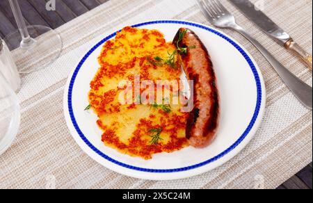 German potato pancakes, kartoffelpuffer, with fried frankfurter Stock Photo