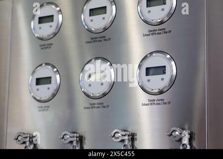 Industrial stainless steel control panel with digital gauges. Selective focus. Stock Photo
