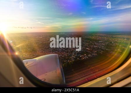 View from the window of an airplane as it takes off at sunrise. Plane flying low, taking off from the city of Campo Grande - MS, Brazil. Stock Photo