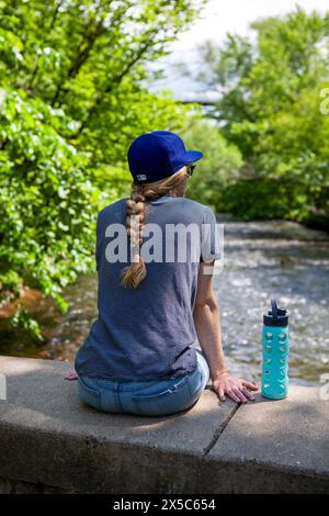 USA, Minnesota. A woman at the falls in Grand Portage State Park on ...