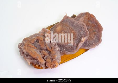 Tiny Thai coconut pancakes or Khanom Babin, a traditional dessert made from sticky rice and grated coconut, on banana leaf Stock Photo