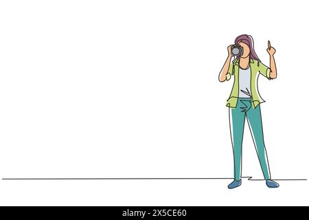 Continuous one line drawing woman photographer using professional camera in the studio. Female standing and giving count gesturing for taking pictures Stock Vector