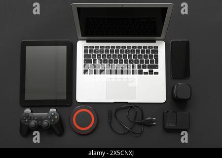 Composition with different modern gadgets on dark background Stock Photo