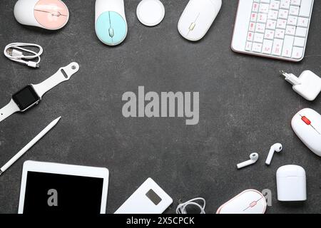 Frame made of different modern gadgets on dark background Stock Photo