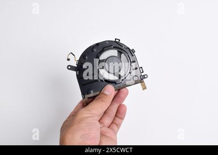 Hand holding Cooling system for laptop or notebook isolated on white background. CPU cooler for laptop Stock Photo