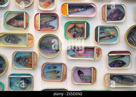 Hampstead Heath, London, UK. 8th May, 2024. Affordable Art Fair presents contemporary art from an impressive roster of local and international galleries from 15 countries, an exhibit of sardine tin art by Ortaire de Coupigny cover an area of wall on the London Contemporary Art stand. Credit: Malcolm Park/Alamy Live News Stock Photo