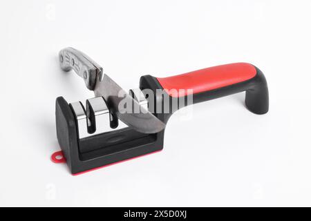 Knife and knife Sharpener isolated on white background. Manual knife sharpening, Kitchen tools Stock Photo