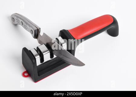 Knife and knife Sharpener isolated on white background. Manual knife sharpening, Kitchen tools Stock Photo
