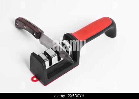 Knife and knife Sharpener isolated on white background. Manual knife sharpening, Kitchen tools Stock Photo