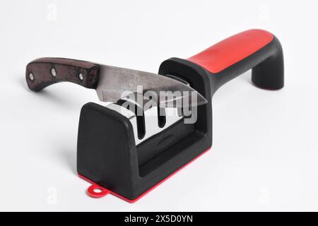 Knife and knife Sharpener isolated on white background. Manual knife sharpening, Kitchen tools Stock Photo