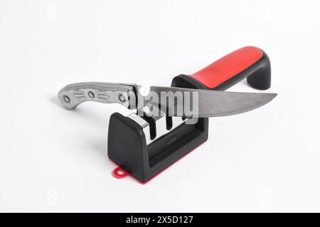Knife and knife Sharpener isolated on white background. Manual knife sharpening, Kitchen tools Stock Photo