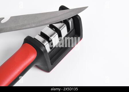 Knife and knife Sharpener isolated on white background. Manual knife sharpening, Kitchen tools Stock Photo