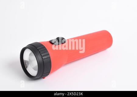 Red color flashlight isolated on white background. Red Battery-powered flashlight Stock Photo