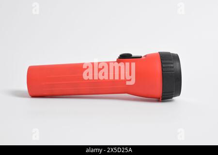 Red color flashlight isolated on white background. Red Battery-powered flashlight Stock Photo
