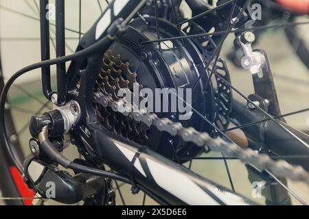 Electric motor and gears on rear e-bike hub close-up. Transport Stock Photo