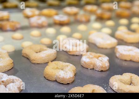 Automated biscuit cookies shape forming machine close-up. Food Stock Photo