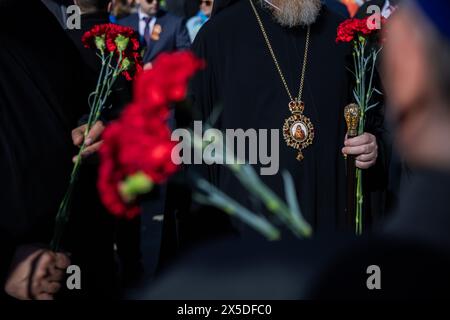 Berlin, Germany. 09th May, 2024. Russian Orthodox clergymen hold flowers at the Soviet memorial in Treptow Park. May 8 and 9 marks the 79th anniversary of the liberation from National Socialism. Credit: Christoph Soeder/dpa/Alamy Live News Stock Photo