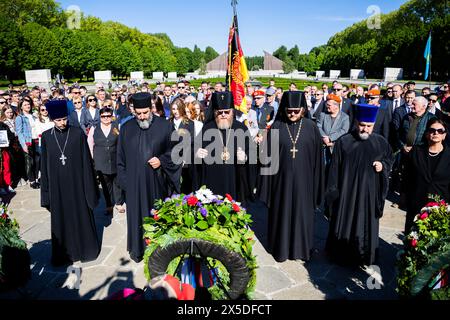 Berlin, Germany. 09th May, 2024. Russian Orthodox clergymen stand in front of memorial wreaths at the Soviet memorial in Treptow Park. May 8 and 9 marks the 79th anniversary of the liberation from National Socialism. Credit: Christoph Soeder/dpa/Alamy Live News Stock Photo